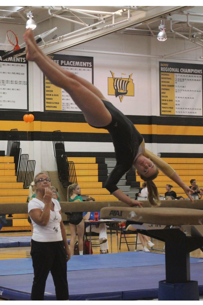 Senior, Paige Parker competing on vault.