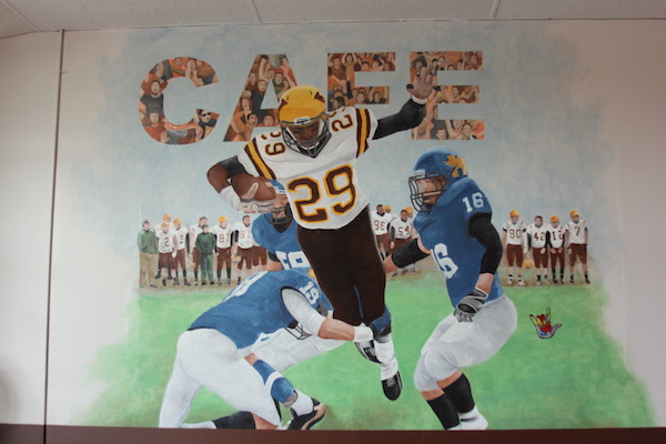 A mural in Cafe 29 depicts Andre in the state championship game against Hutchinson in 2012. Photo by Kelsea Lilla.