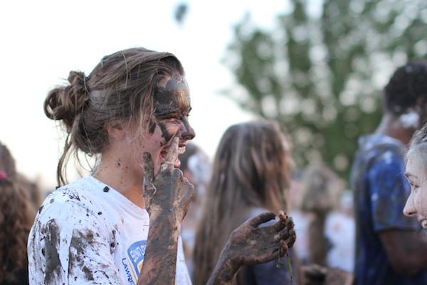 Senior Erin Fast points to mud on her face. Photo by Merani Rivarola.