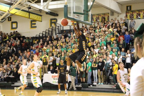 Senior Darrell Stewart hangs on the rim after a dunk.