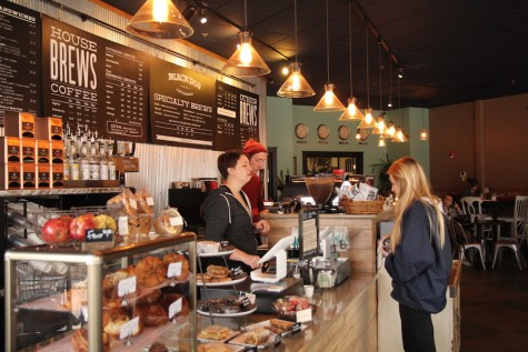 A customer orders at Black Dogs well-adorned front counter. Photo by Jenna Wilson.