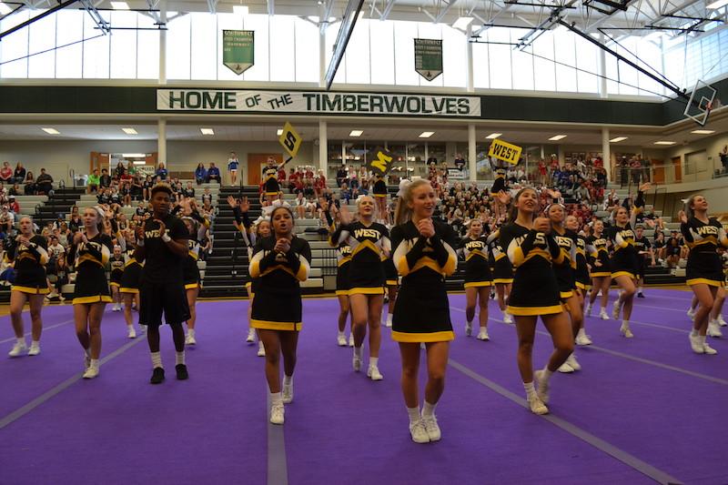 The cheer squad performs their opening chant in front of a large crowd