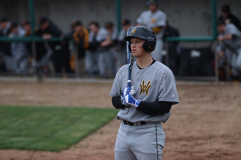 Cameron Stout, senior, stands in the on-deck circle awaiting next at-bat.