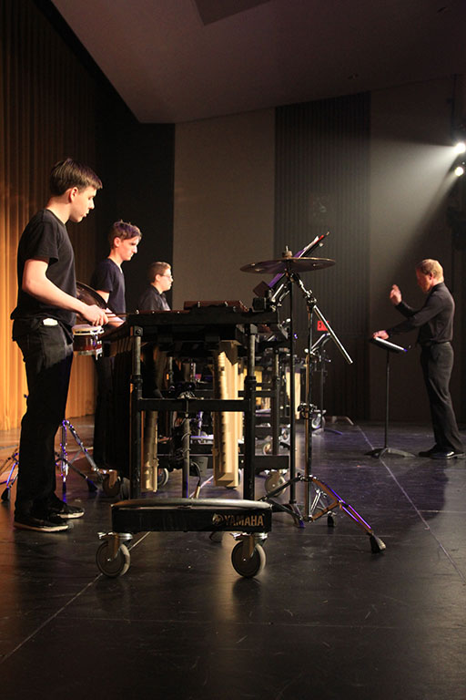 Sean Perkins and other percussionists play the xylophone.