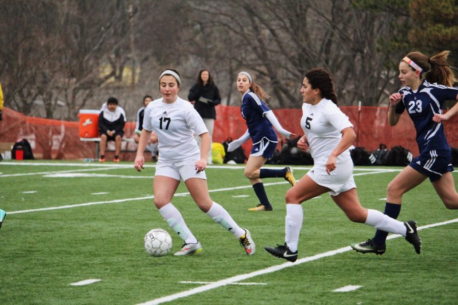 Ali Serrano and Naomi Oliva team up to score a goal. 