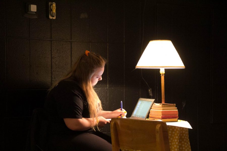 Senior Paige Kring works at a desk before Beatnik starts. 