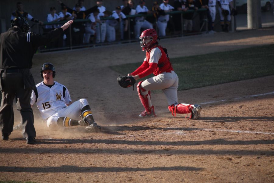 Freshman Matt Adams is called safe at home plate.