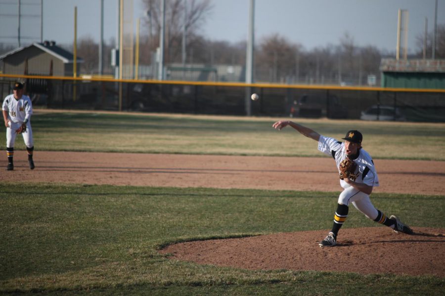 Senior Brandon Cooper throws a pitch towards home plate. 