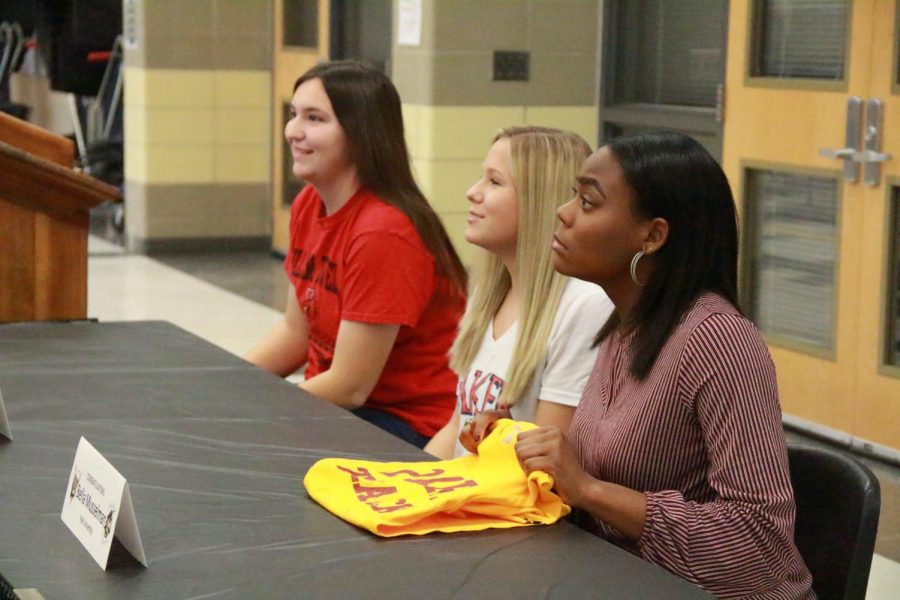 Seniors, Katie Wagenheim, Mattie Chambers, and Bella  Musselman posing for pictures taken by their family.