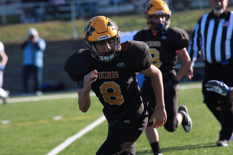 Freshman Anthony Fleming #8 and Jonah Dolphino #3 
charging towards the ball  