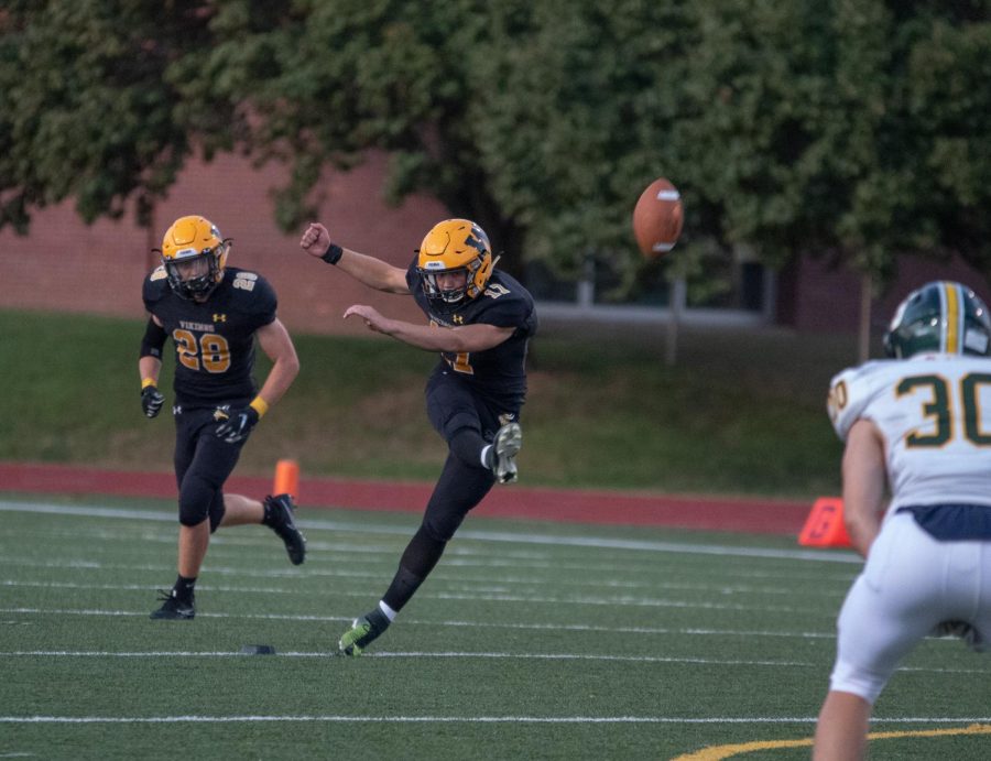 Michael Cooper starting a play with a kick off.