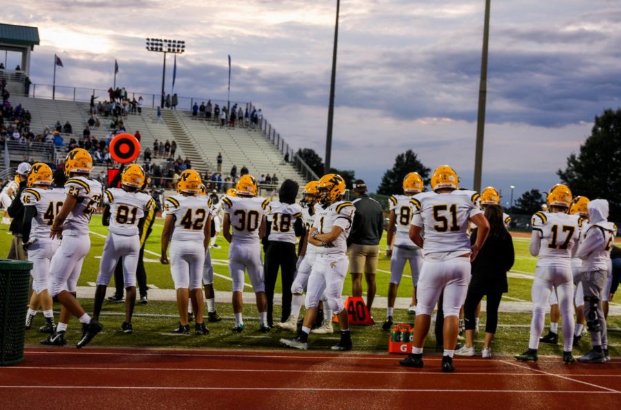 Players standing on the sideline ready to go in.