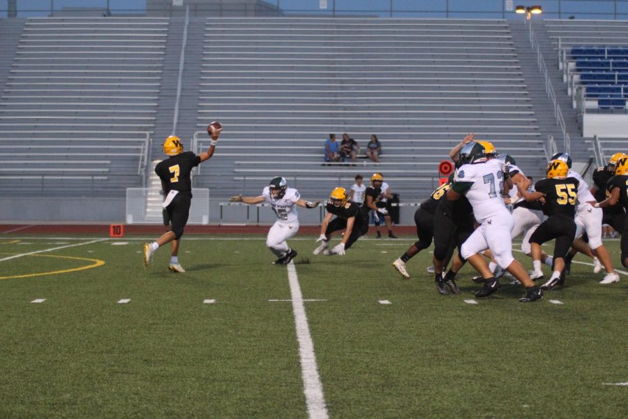 Weston Moore passing the ball to his fellow teamates . 