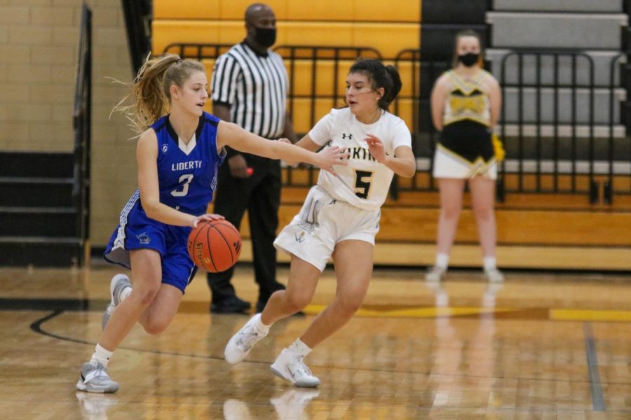 Aaliyah Garcia plays defense against Liberty High School during a Varsity Girls Basketball game. Photo taken by Morgan Brewer.