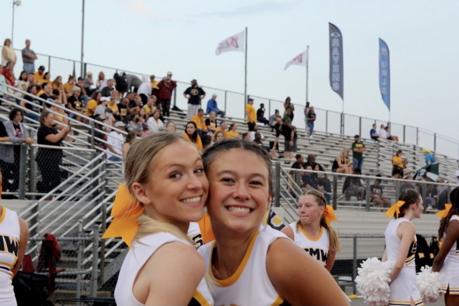Brodie Rawie and Megan Brethauer featured posing for a quick picture amidst cheering for the SMW football team. 