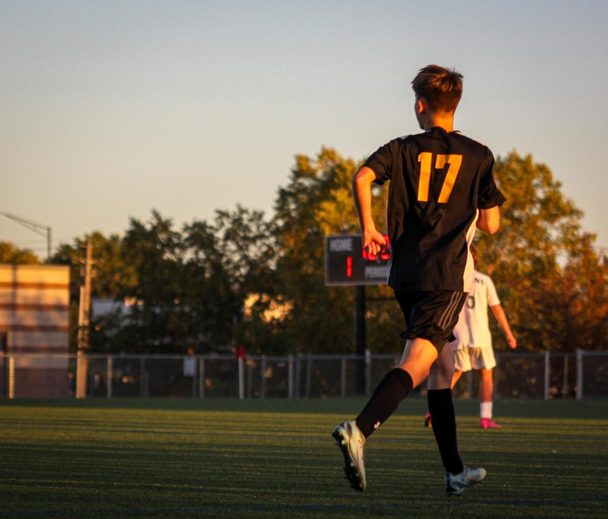 Junior%2C+Jordan+Christensen%2C+playing+in+the+JV+Soccer+Game+while+the+sun+sets+behind+him.+19%2F10%2F2023%0A